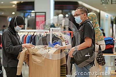 Hijab Malay Muslim lady with her son and daughter doing shopping in big modern city mall Editorial Stock Photo