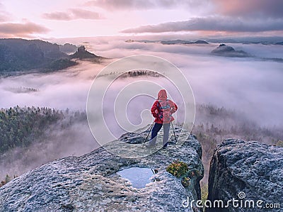 Hike with backpack and trekking sticks at edge. Woman visit Stock Photo