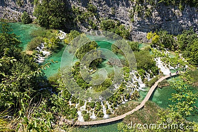 Hike path trough the lake besides the waterfall Stock Photo