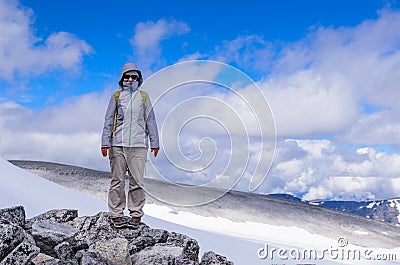 Hiker above the Grjotbreen glacier Stock Photo