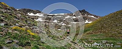 Hiker ascending mountain panorama Stock Photo