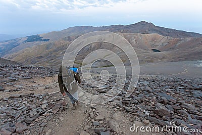 Hiker ascending Mulhacen in Sierra Nevada, Spain Stock Photo