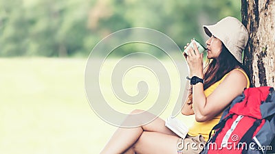 Hiker asian woman sitting and drinking coffee for relax and rest on mountain. Stock Photo