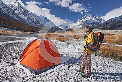 Hiker with backpack at camping in the mountains during springtime. Stock Photo