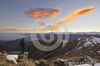 Hiker with backpacking observes the Alps Stock Photo