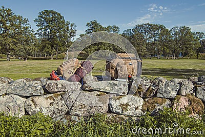 Hiker backpacks on limestone fence landscape photo Stock Photo