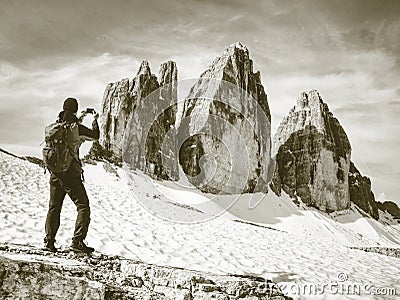 Hiker with backpacks on trail around the mountain peaks. Stock Photo