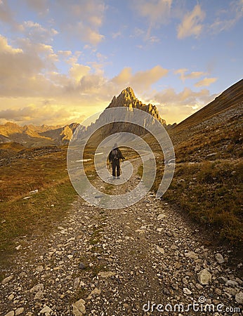 Hiker on a beautiful road in the mountains Stock Photo