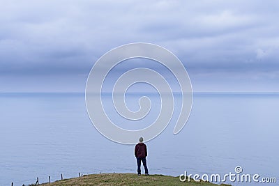 Hiker on the coast of Euskadi Stock Photo