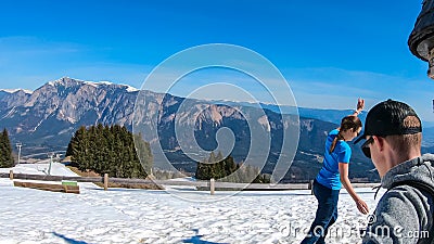 Dreilaendereck - Hiker couple walking on snow covered meadow at Dreilaendereck, Karawanks, Carinthia, Austria Stock Photo