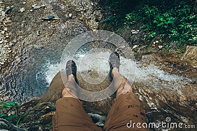 Hiker Explorer Sitting On Cliff With Waterfall View. Travel Lifestyle Adventure Vacations Concept Stock Photo