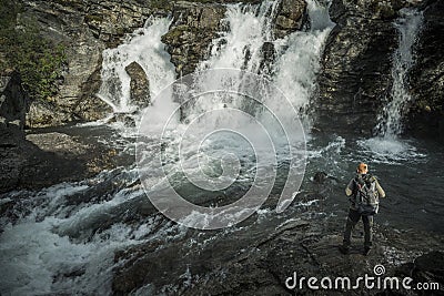 Hiker Exploring River Gorge and the Scenic Waterfalls Stock Photo