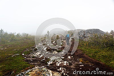Hiker on foggy trail Stock Photo