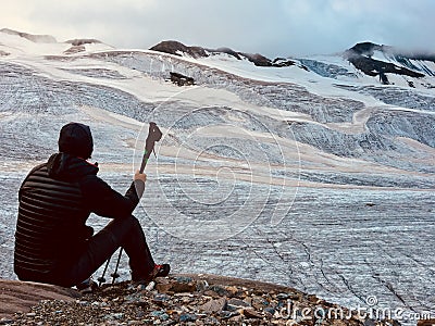 Hiker in front of a great alpine glacier. Back view. Italian Alp Stock Photo