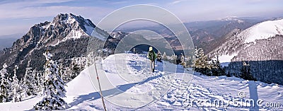 Hiker goes down from frozen mountains Stock Photo