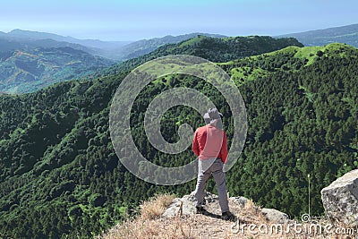Hiker With Hat Looking Down On Trees Covered Mountains Editorial Stock Photo