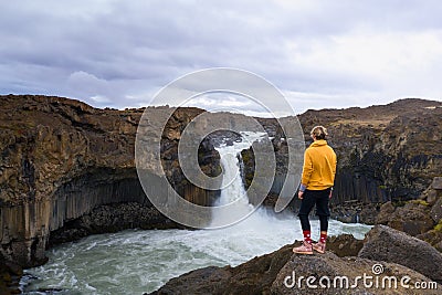 Hiker looks at the Aldeyjarfoss waterfall in Iceland Stock Photo