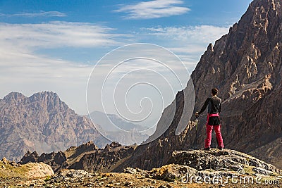 Hiker man stays on the mountain hill Stock Photo