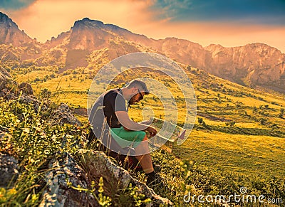 The Hiker with a Map in Misty Mountains Stock Photo