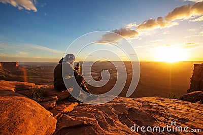 Hiker meets sunset at Grand view point in Canyonlands National p Stock Photo