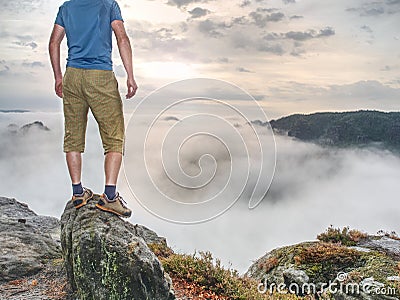 Hiker in middle of nowhere and thinking alone. Man sit on top Stock Photo
