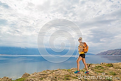 Hiker with pack overlooking Adriatic Sea, Rab Island, Croatia Stock Photo