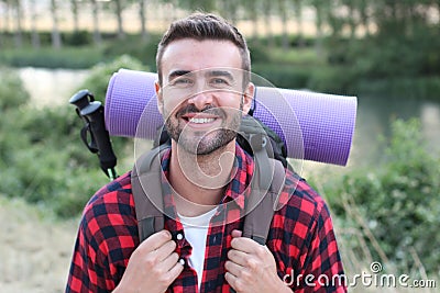 Hiker portrait. Male hiking man happy and smiling during hike trek. Beautiful young sporty model joyful Stock Photo