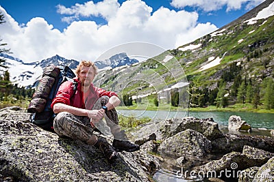 Hiker is posing at camera in mountains of Altai Stock Photo