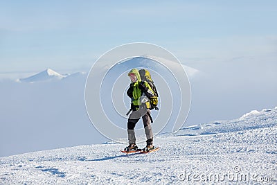 Hiker posing at camera in winter mountains Stock Photo