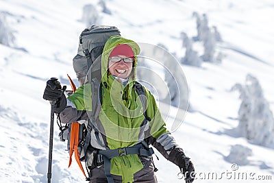 Hiker posing at camera in winter mountains Stock Photo