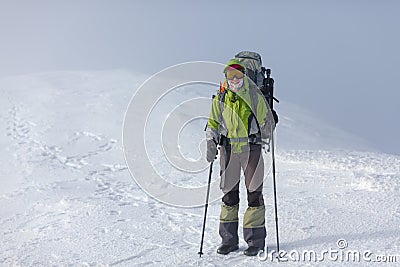 Hiker posing at camera in winter mountains Stock Photo