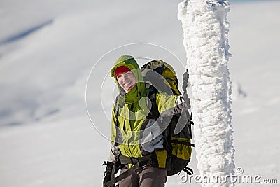 Hiker posing at camera in winter mountains Stock Photo