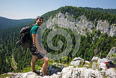 Hiker posing on a very high cliff Stock Photo