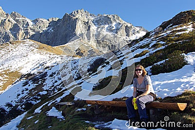 Hiker resting on bench Stock Photo