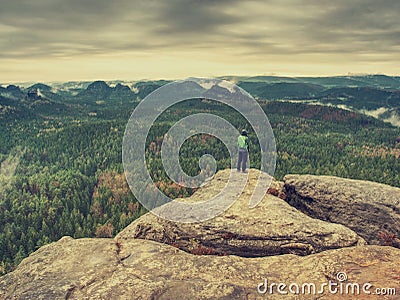 Hiker on rocky trail walking on mountain ridge. End of summer Stock Photo