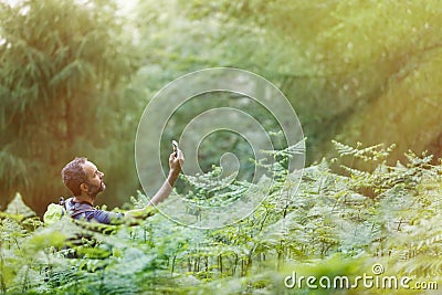 Hiker searching a mobile phone signal, being lost Stock Photo