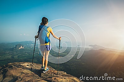 Hiker stand on mountain peak cliff edge Stock Photo