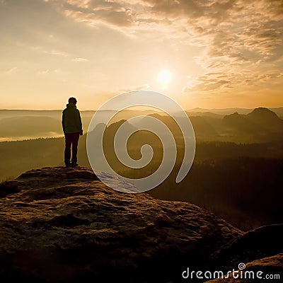 Hiker stand on the sharp corner of sandstone rock in rock empires park and watching over the misty and foggy morning valley to Sun Stock Photo