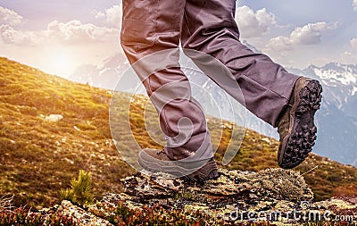 Hiker standing on top of a mountain and enjoying sunrise Stock Photo