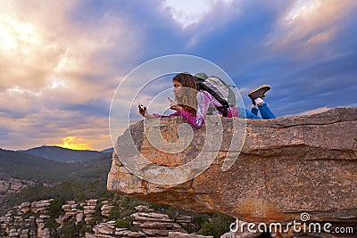 Hiker teen girl selfie phone on peak of mountain Stock Photo