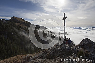Hiker on top to summit Taubenstein mountain, Bavaria Stock Photo