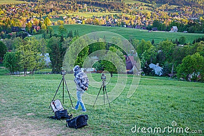 Hiker tourist professional photography shooting on tripod in mountains Editorial Stock Photo