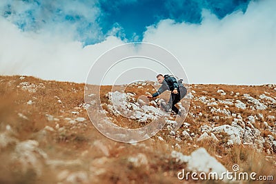 Hiker trail hiking mountain. Young sports man outdoor. Stock Photo
