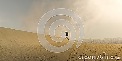 Hiker Trudging through desert sand dunes in Death Valley National Park Stock Photo