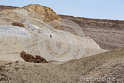 Hiker Trudging up a Steep Desert Trail in the Negev in Israel Stock Photo