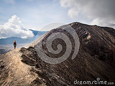 Hiker Walking Around Rim of Gunung Bromo Volcano, Java, Indonesia Stock Photo