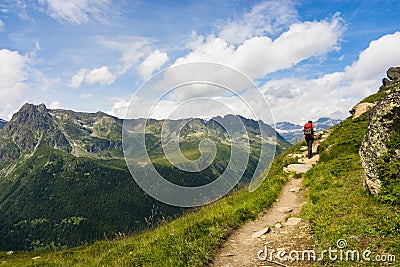 Hiker walking on a beautiful path in Aiguilles Rouges Stock Photo