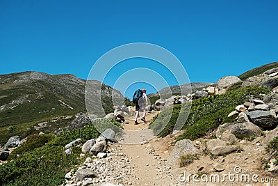 hiker walking on Besseggen ridge in Jotunheimen National Stock Photo