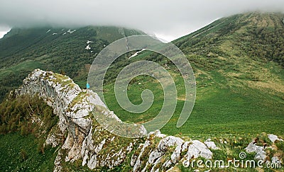 Hiker walking on cliff wall. Stock Photo