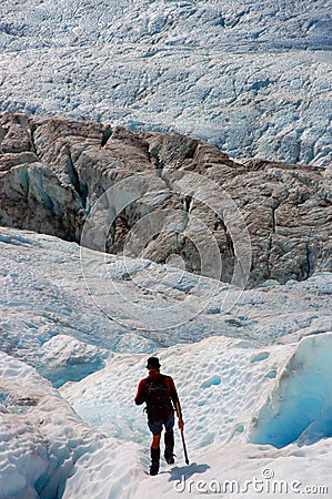 A Hiker walking on ice in the Franz Josef glacier at the southern island of New Zealand Editorial Stock Photo